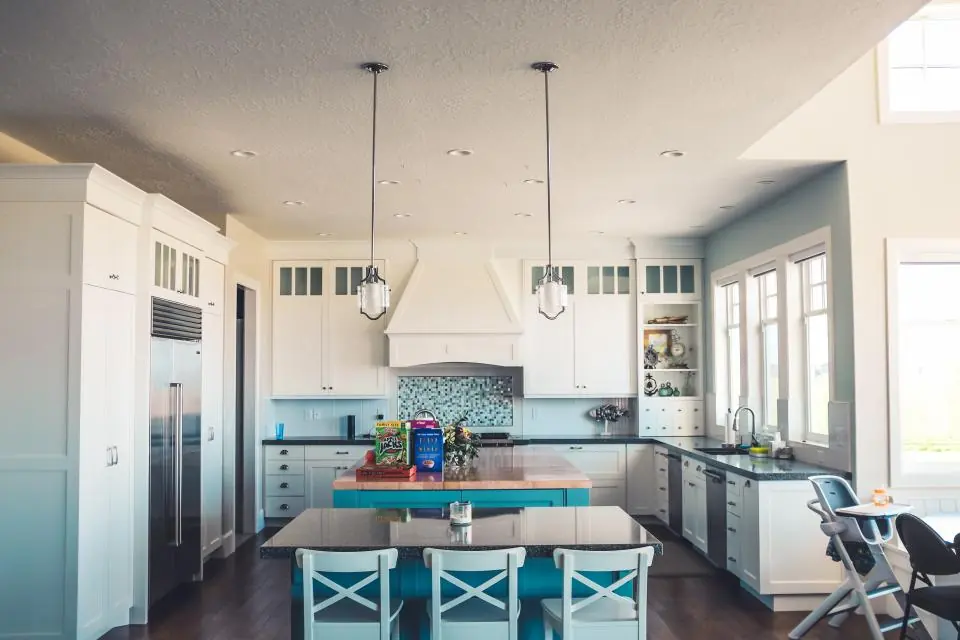 A clean, bright kitchen with white cabinets and an island